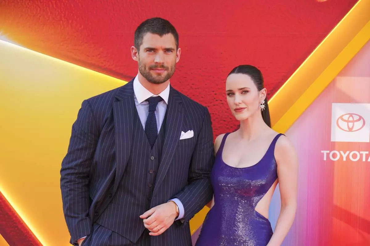 CORRECTS ORDER OF PEOPLE - David Corenswet , left, and Rachel Brosnahan arrive at the premiere of "Superman" on Monday, July 7, 2025, at TCL Chinese Theatre in Los Angeles. (Photo by Jordan Strauss/Invision/AP)