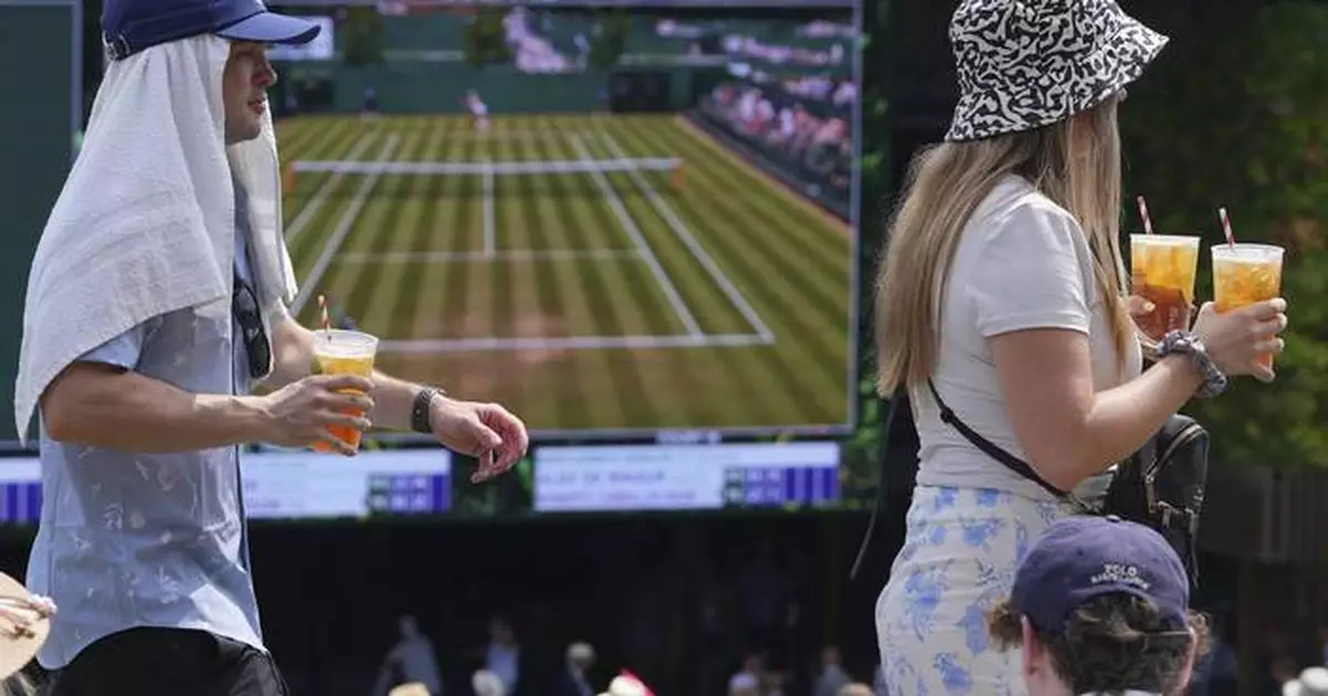 Photos of Wimbledon fans and players struggling to stay cool in record-breaking heat