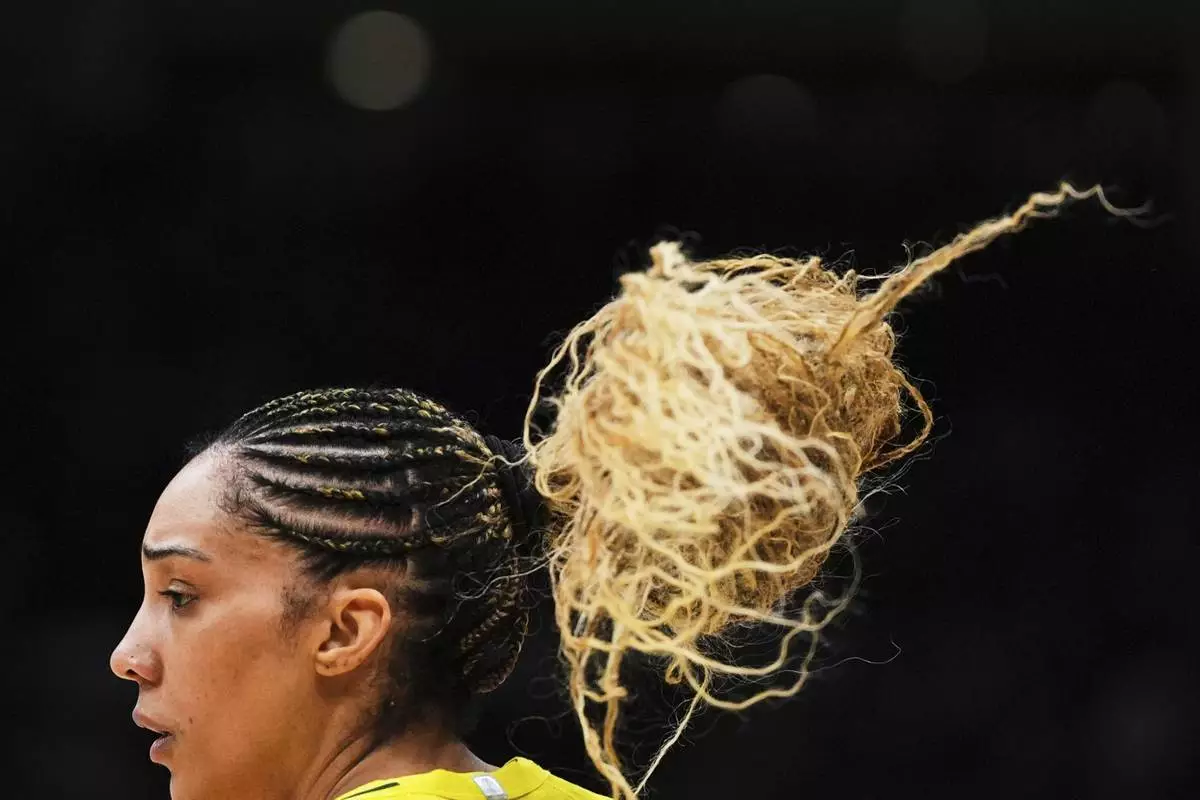 The hair of Seattle Storm forward Gabby Williams bounces as she faces the New York Liberty during the second half of a WNBA basketball game Sunday, June 22, 2025, in Seattle. (AP Photo/Lindsey Wasson)