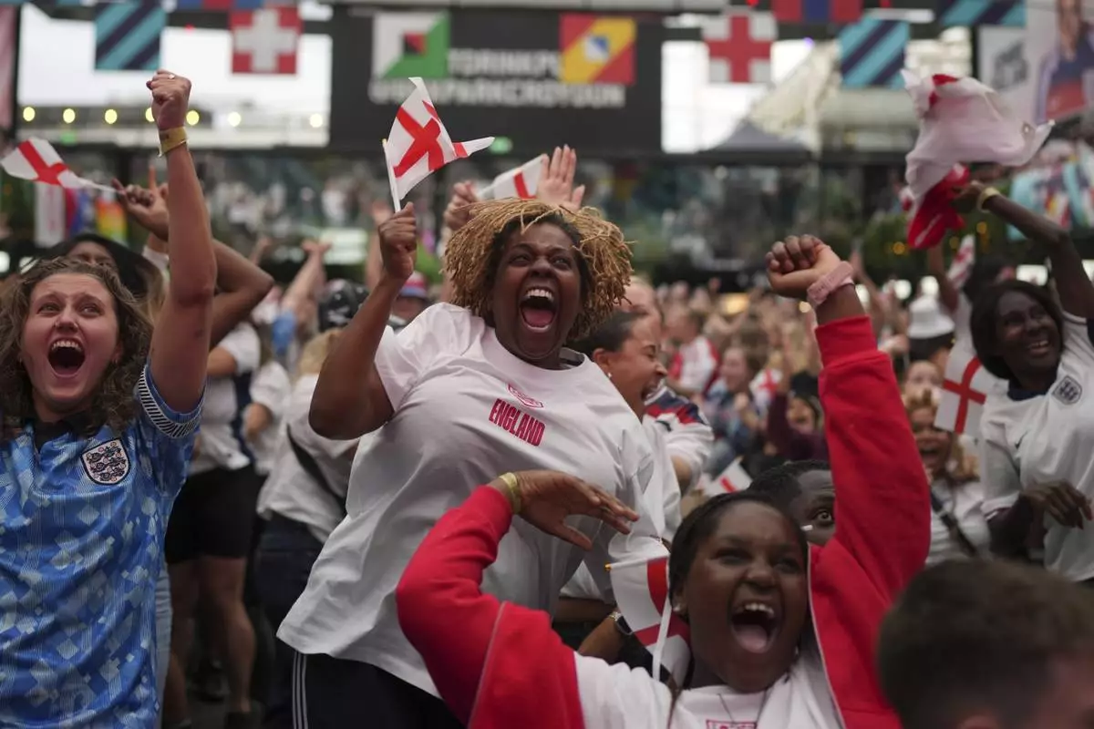 England supporters celebrate during a live screening of the Women's Euro 2025 final soccer match between England and Spain at the Boxpark in Croydon, London, Sunday, July 27, 2025.(AP Photo/Kin Cheung)