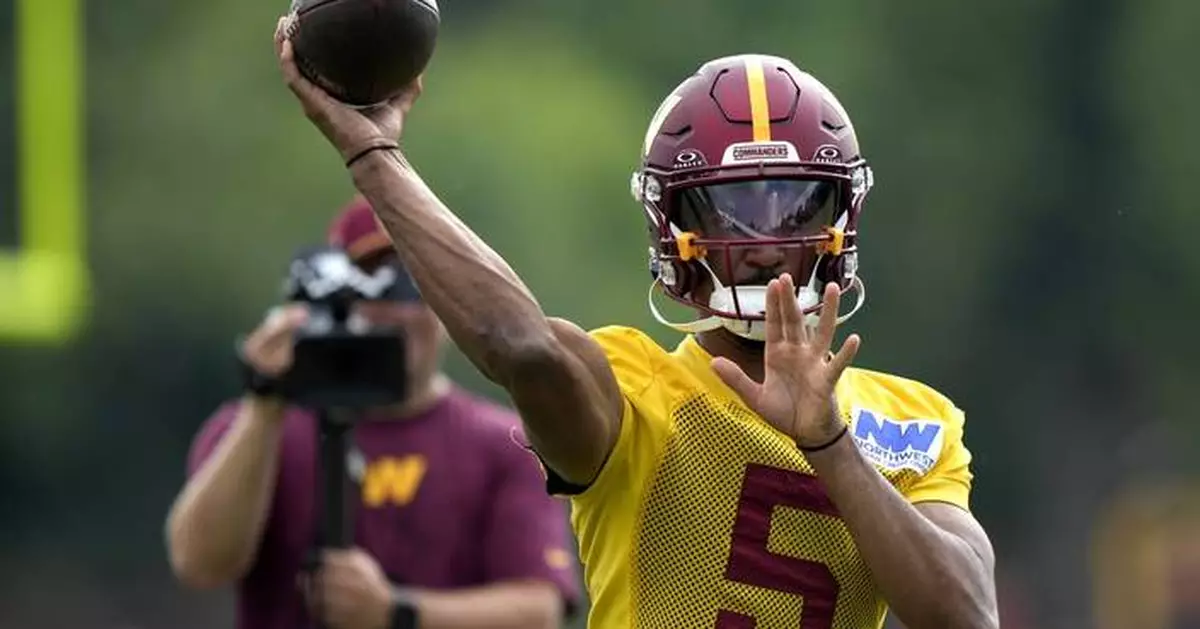 Jayden Daniels' first 11-on-11 throw of camp is an over-the-shoulder connection with Deebo Samuel