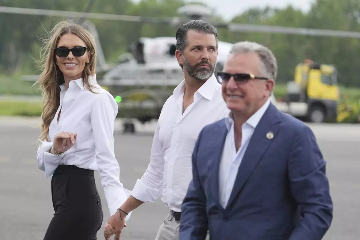 White House special envoy Steve Witkoff, from right, Donald Trump Jr., and Bettina Anderson watch as President Donald Trump arrives at Teterboro Airport in Teterboro, N.J., en route to attend the Club World Cup final soccer match, Sunday, July 13, 2025. (AP Photo/Jacquelyn Martin)