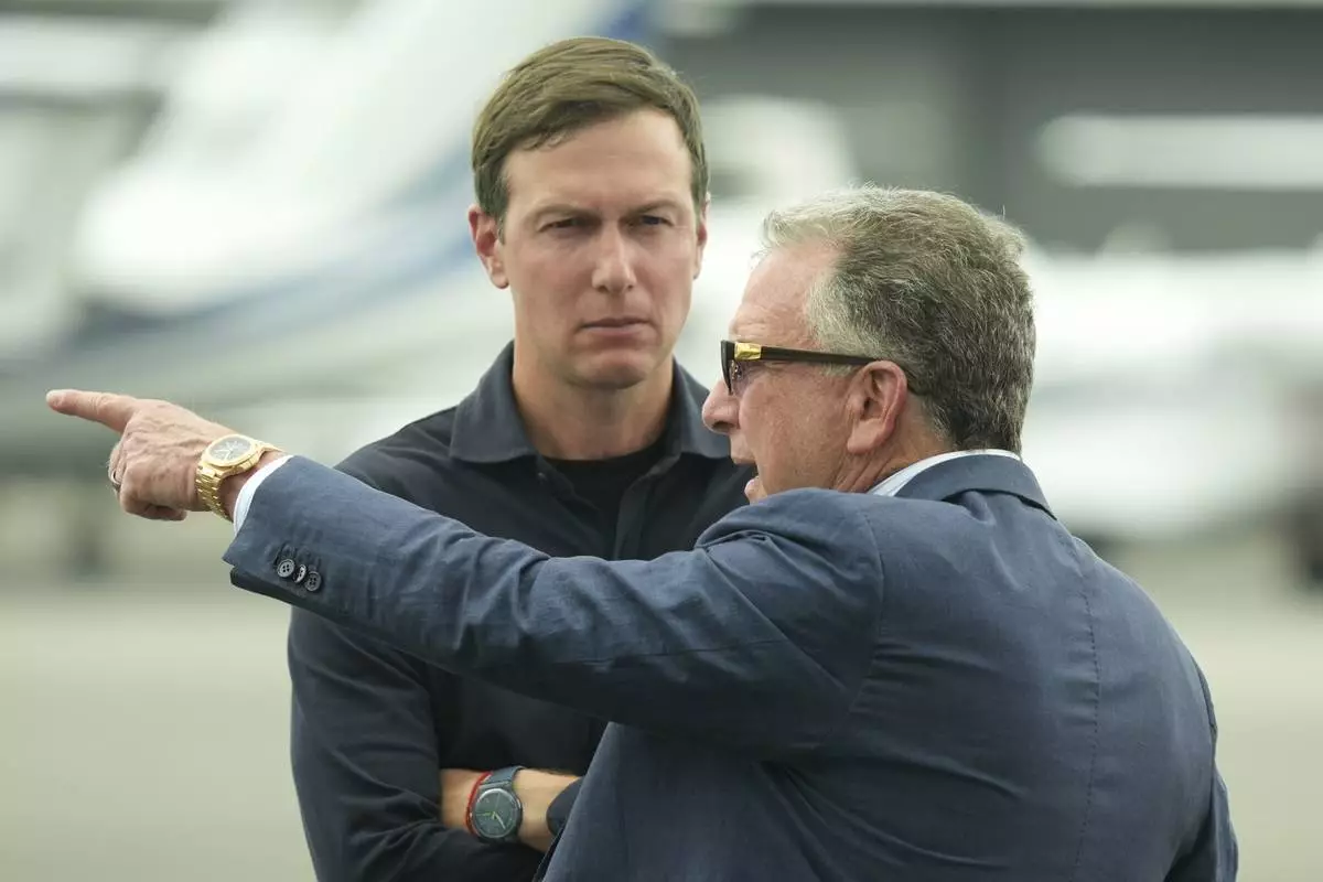 White House special envoy Steve Witkoff, right, and Jared Kushner wait for the arrival of President Donald Trump at Teterboro Airport in Teterboro, N.J., en route to attend the Club World Cup final soccer match, Sunday, July 13, 2025. (AP Photo/Jacquelyn Martin)