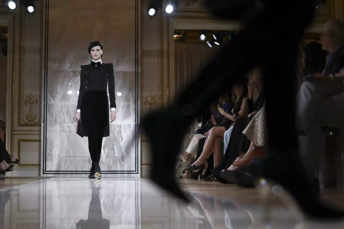 A model wears a creation as part of the Giorgio Armani Prive Fall-Winter 2025/26 Haute Couture collection presented Tuesday, July 8, 2025, in Paris. (AP Photo/Tom Nicholson)