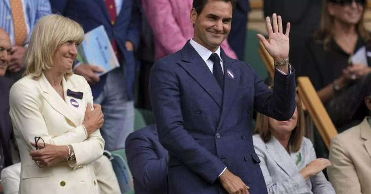 Roger Federer sits in Wimbledon's Royal Box to watch rival Novak Djokovic win