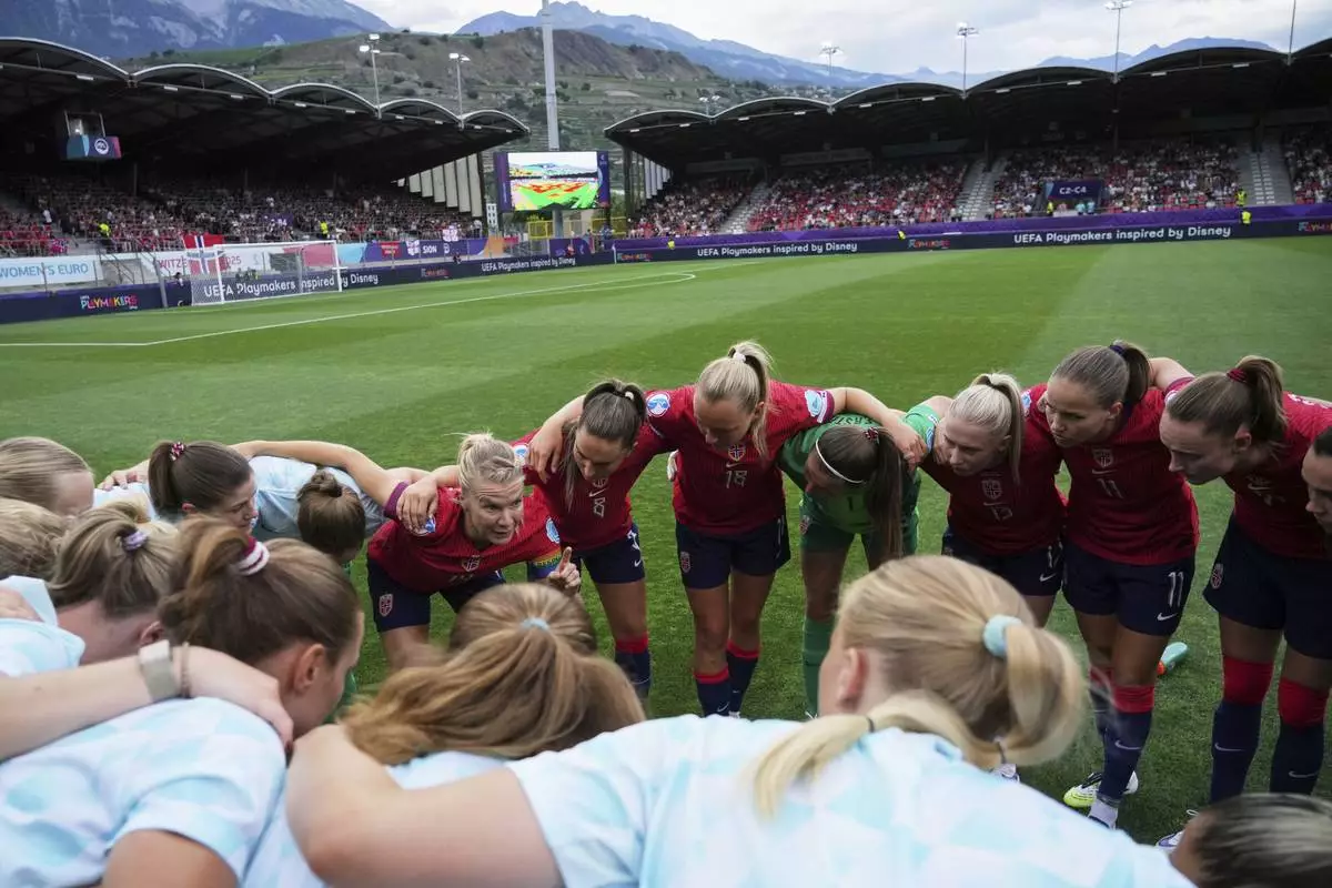 Norway's team captain Ada Hegerberg, at left, speaks to her teammates before the start of the Euro 2025, group A, soccer match between Norway and Finland at Stade de Tourbillon in Sion, Switzerland, Sunday, July 6, 2025. (AP Photo/Alessandra Tarantino)