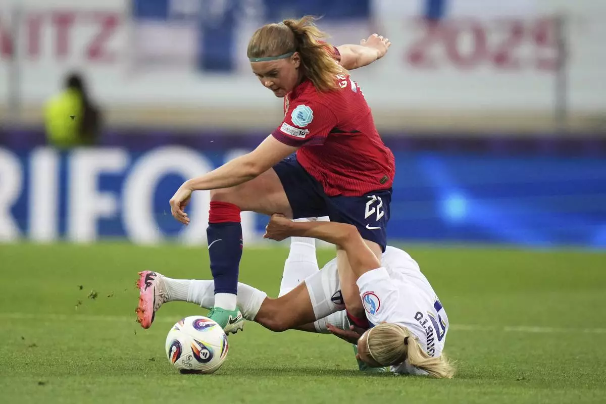 Norway's Signe Gaupset fights for the ball with Finland 's Emma Koivisto, on the ground, during the Euro 2025, group A, soccer match between Norway and Finland at Stade de Tourbillon in Sion, Switzerland, Sunday, July 6, 2025. (AP Photo/Alessandra Tarantino)