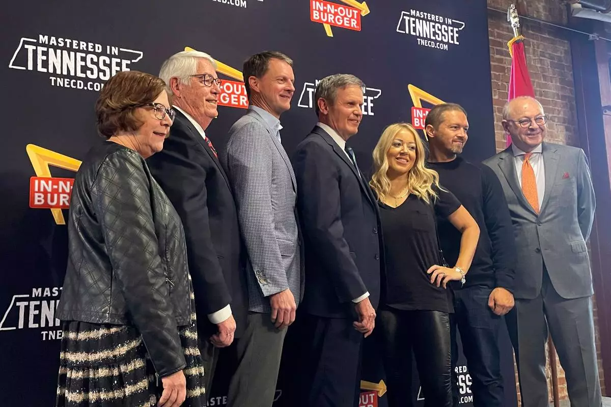 FILE - Tennessee Gov. Bill Lee, center, poses with In-N-Out Burger owner and President Lynsi Snyder, to his right, in Franklin, Tenn., on Jan. 10, 2023. (AP Photo/Jonathan Mattise, File)