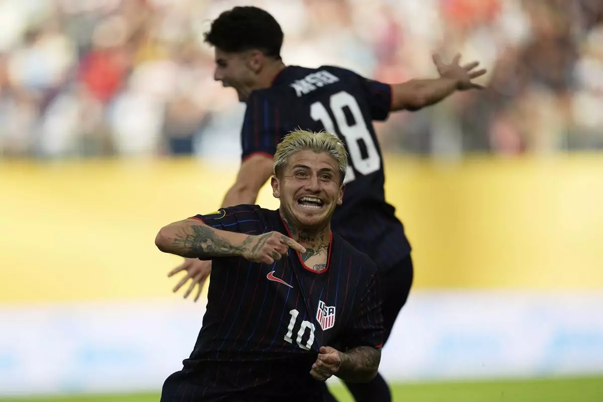 United States midfielder Diego Angel Luna (10) celebrates next to midfielder Maximilian Michael Arfsten (18) after scoring during the first half of a CONCACAF Gold Cup quarterfinals soccer match against Costa Rica, Sunday, June 29, 2025, in Minneapolis. (AP Photo/Abbie Parr)