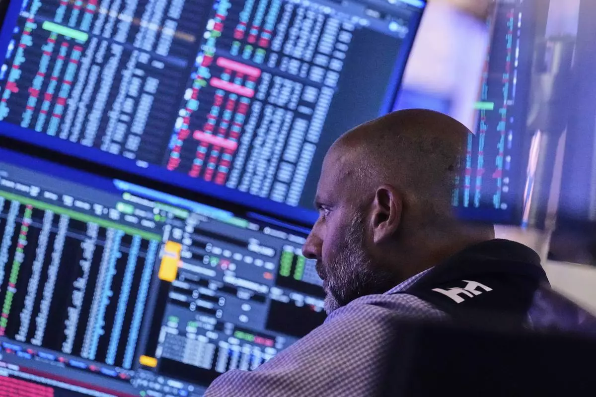 Specialist Meric Greenbaum works at his post on the floor of the New York Stock Exchange, Tuesday, July 8, 2025. (AP Photo/Richard Drew)