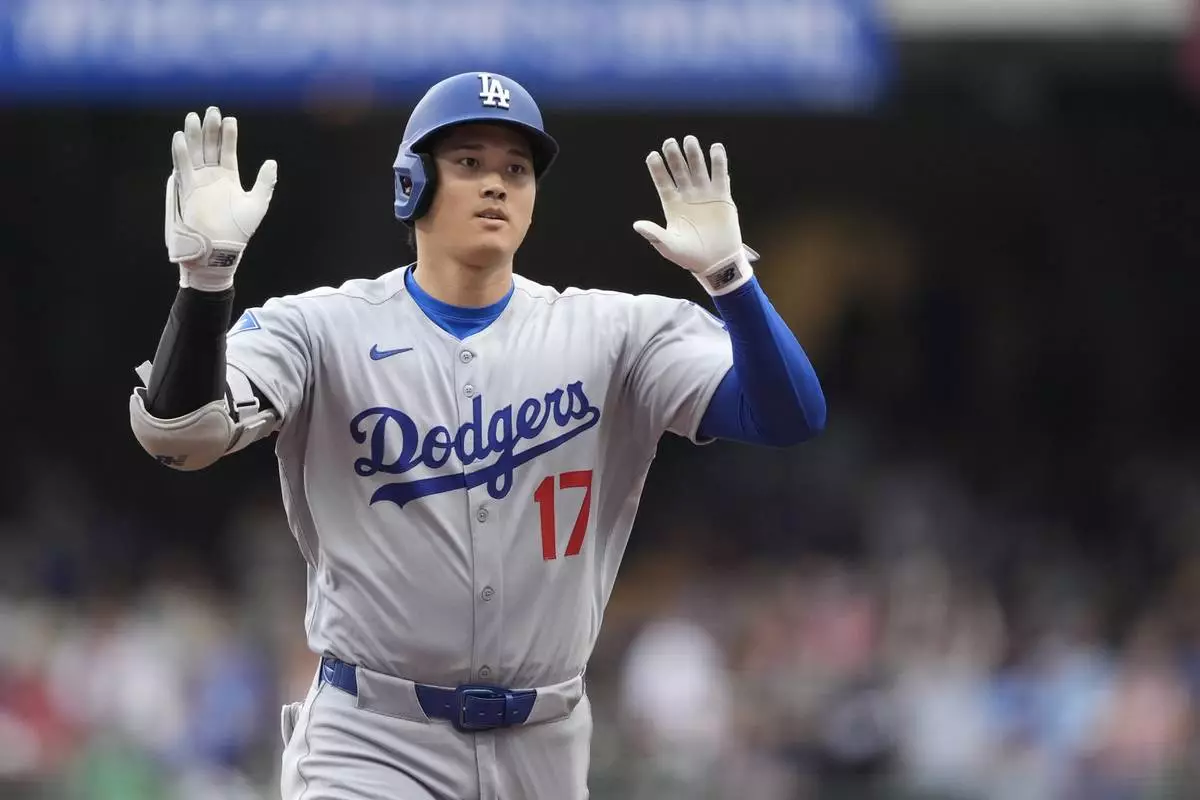 Los Angeles Dodgers' Shohei Ohtani gestures as he rounds the bases after hitting a solo home run during the first inning of a baseball game against the Milwaukee Brewers, Tuesday, July 8, 2025, in Milwaukee. (AP Photo/Aaron Gash)