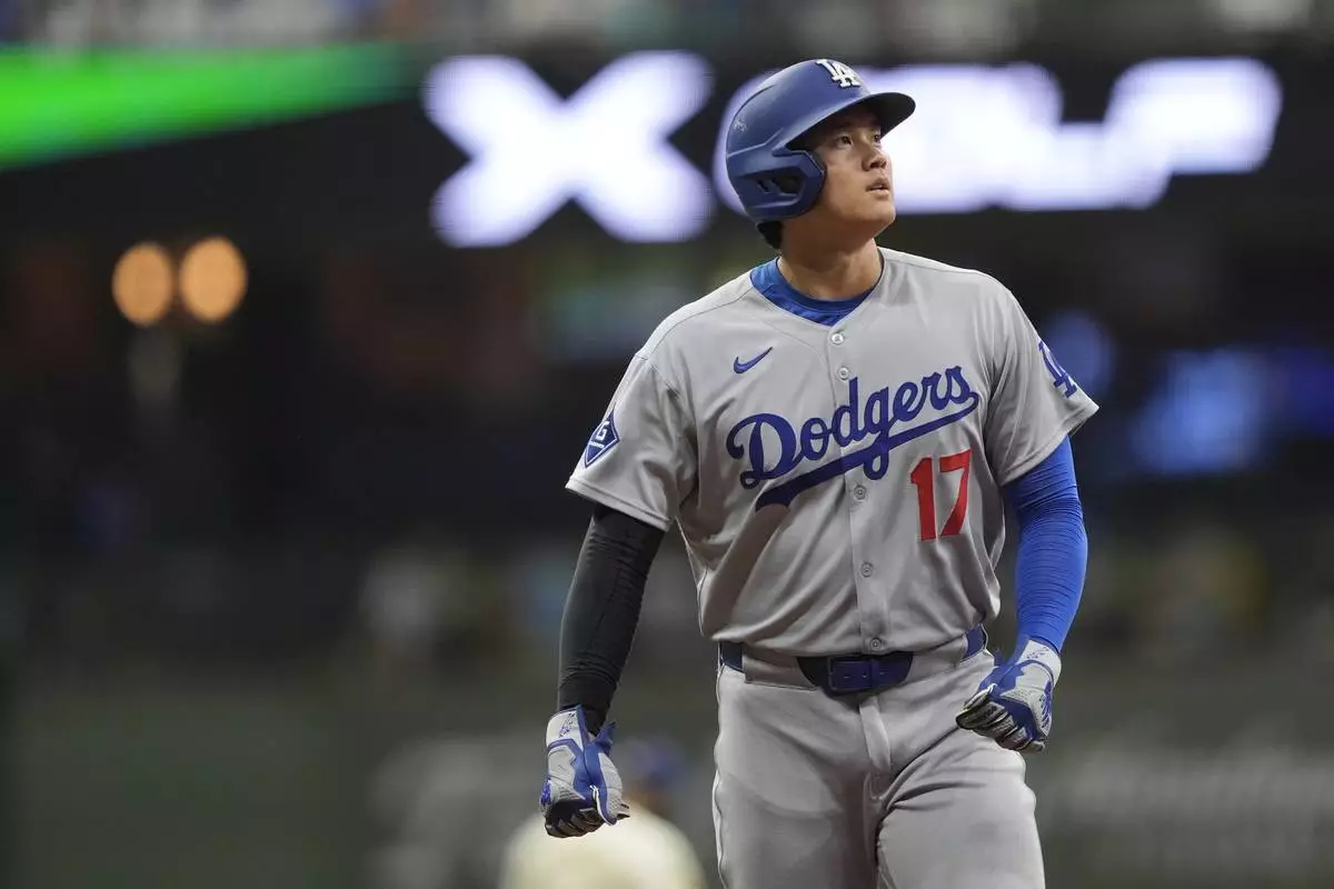 Los Angeles Dodgers' Shohei Ohtani looks on during the eighth inning of a baseball game against the Milwaukee Brewers, Monday, July 7, 2025, in Milwaukee. (AP Photo/Aaron Gash)