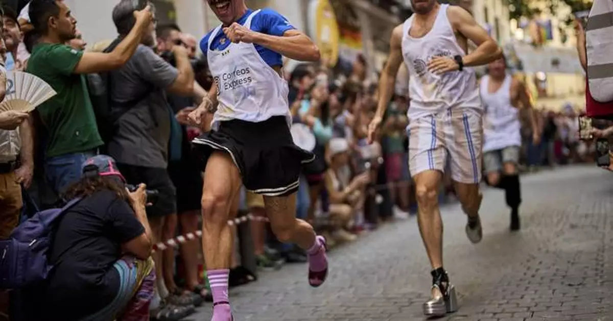 Photos of Madrid's high heel race where runners braved the heat for Pride Week