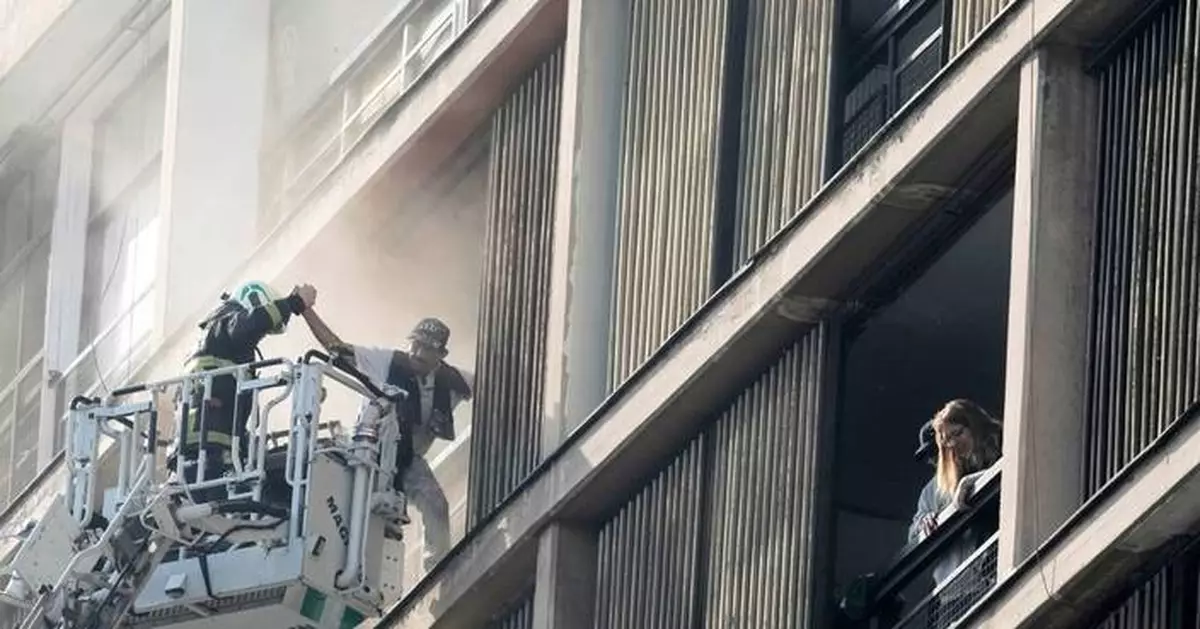 Firefighters rescue dozens from burning high rise in Santiago
