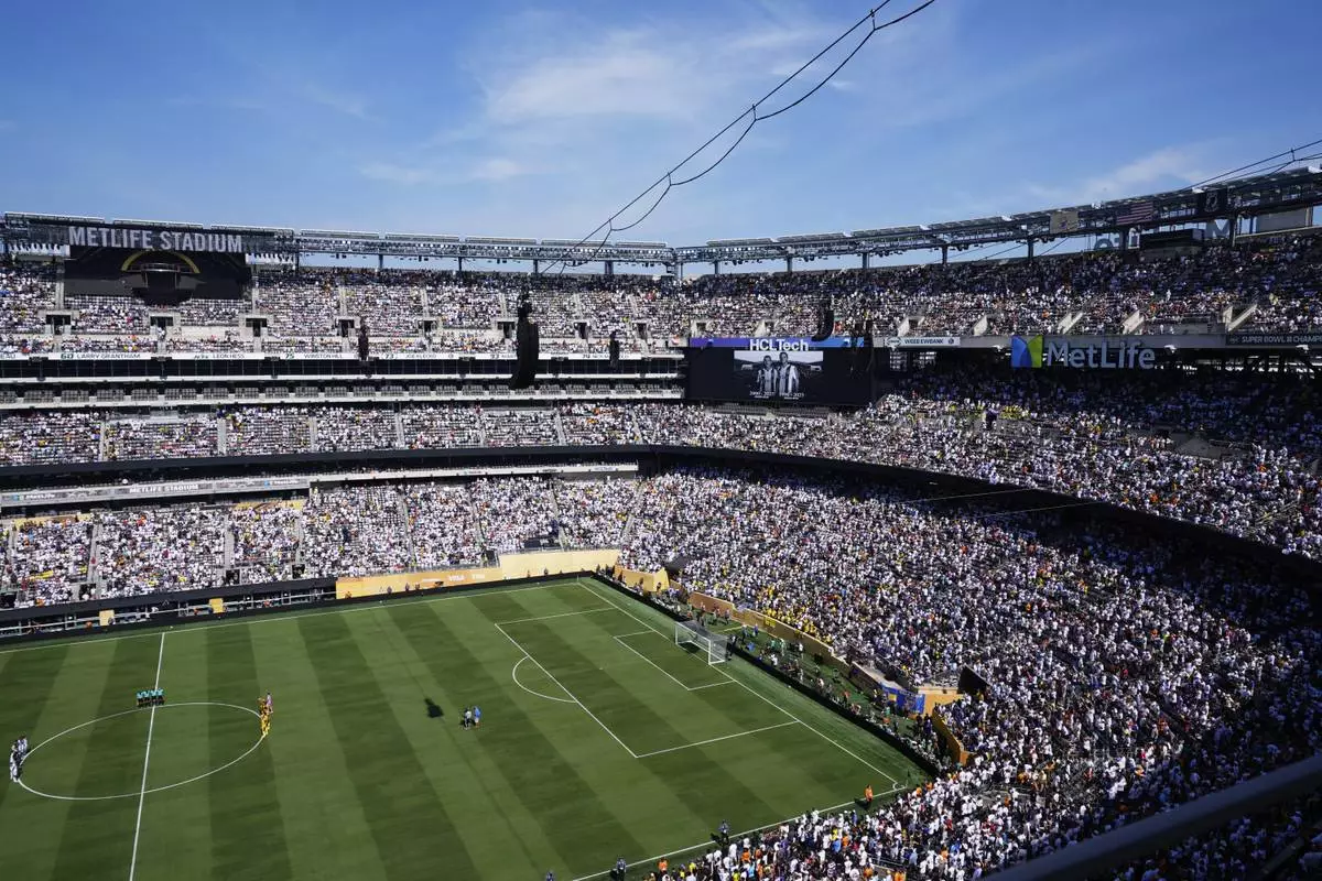 Players and fans observe a minute of silent in memory of Portugal international and Liverpool player Diogo Jota and his brother Andre Silva prior the Club World Cup quarterfinal soccer match between Real Madrid and Borussia Dortmund in East Rutherford, N.J., Saturday, July 5, 2025. (AP Photo/Pamela Smith)