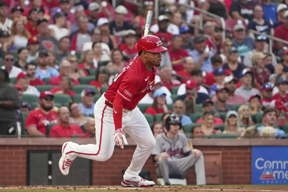 St. Louis Cardinals' Willson Contreras follows through on an RBI single during the first inning of a baseball game against the Atlanta Braves Friday, July 11, 2025, in St. Louis. (AP Photo/Jeff Roberson)