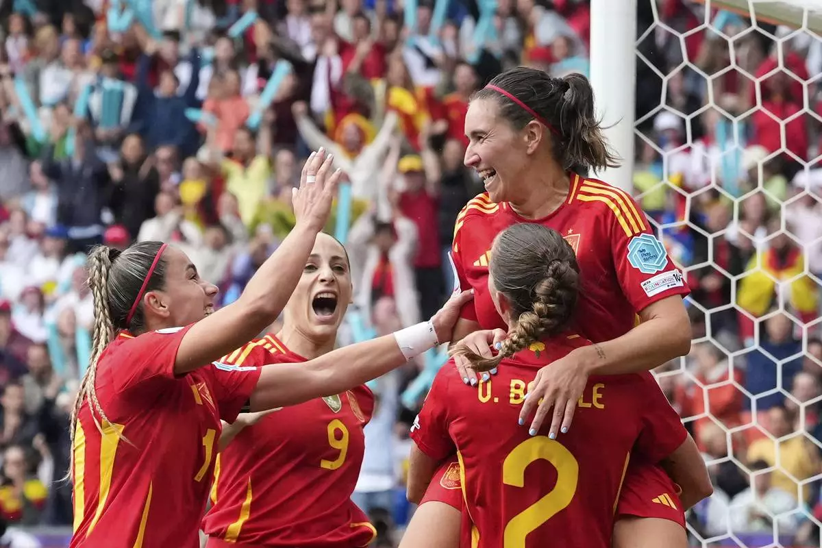 Spain players celebrate after Spain's Mariona Caldentey, right, scored the opening goal during the Women's Euro 2025 final soccer match between England and Spain at St. Jakob-Park in Basel, Switzerland, Sunday, July 27, 2025. (AP Photo/Alessandra Tarantino)