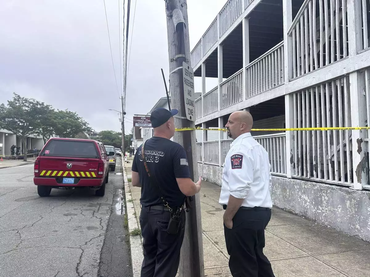 Falls River Fire Chief Jeffrey Bacon, right, speaks with another official after a fire the Gabriel House assisted living facility in Falls River, Mass., Monday, July 14, 2025. (AP Photo/Michael Casey)