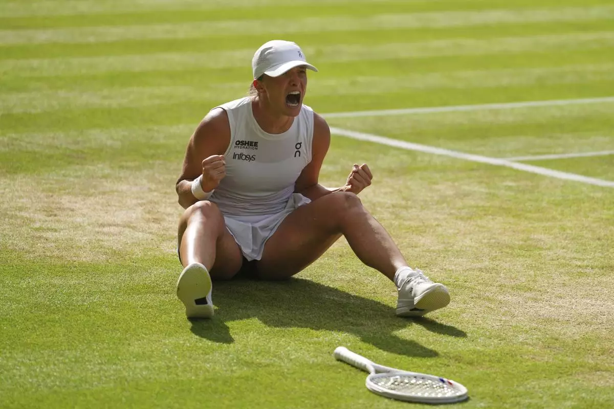 Iga Swiatek of Poland celebrates winning the women's singles final match against Amanda Anisimova of the U.S. at the Wimbledon Tennis Championships in London, Saturday, July 12, 2025.(AP Photo/Kirsty Wigglesworth)