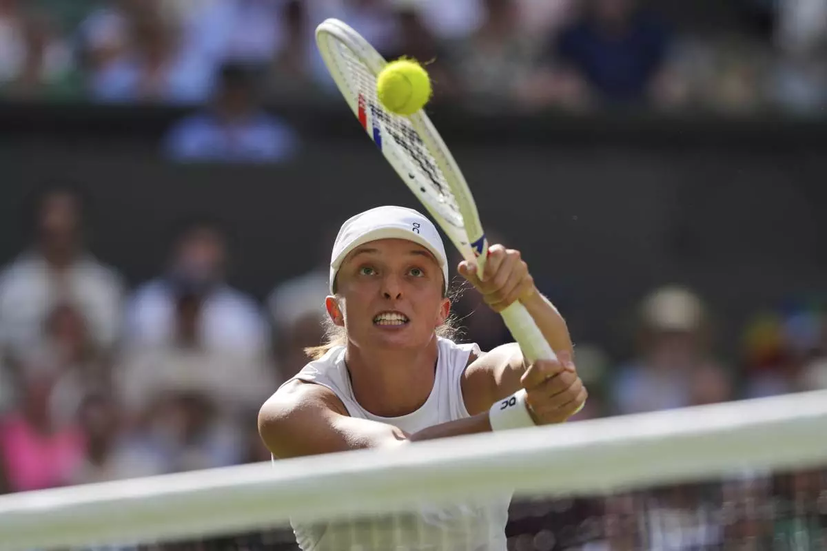 Poland's Iga Swiatek returns to Amanda Anisimova of the U.S. during the women's singles final at the Wimbledon Tennis Championships in London, Saturday, July 12, 2025. (AP Photo/Kin Cheung)