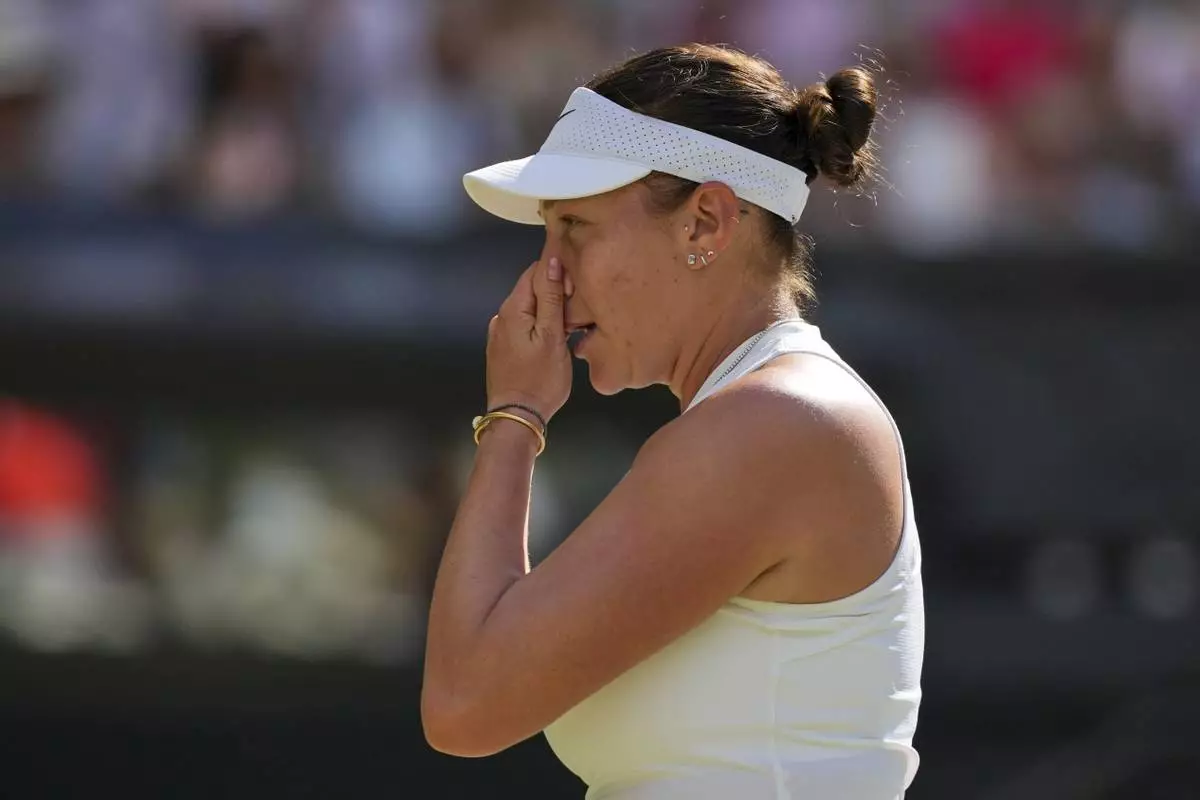 Amanda Anisimova of the U.S. reacts as she plays Poland's Iga Swiatek during the women's singles final at the Wimbledon Tennis Championships in London, Saturday, July 12, 2025. (AP Photo/Kin Cheung)