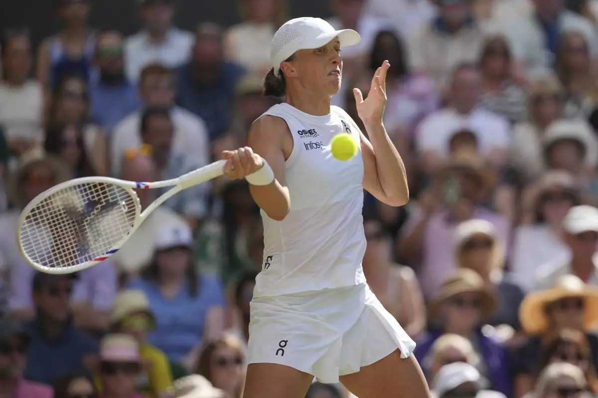 Poland's Iga Swiatek returns to Amanda Anisimova of the U.S. during the women's singles final at the Wimbledon Tennis Championships in London, Saturday, July 12, 2025. (AP Photo/Kin Cheung)
