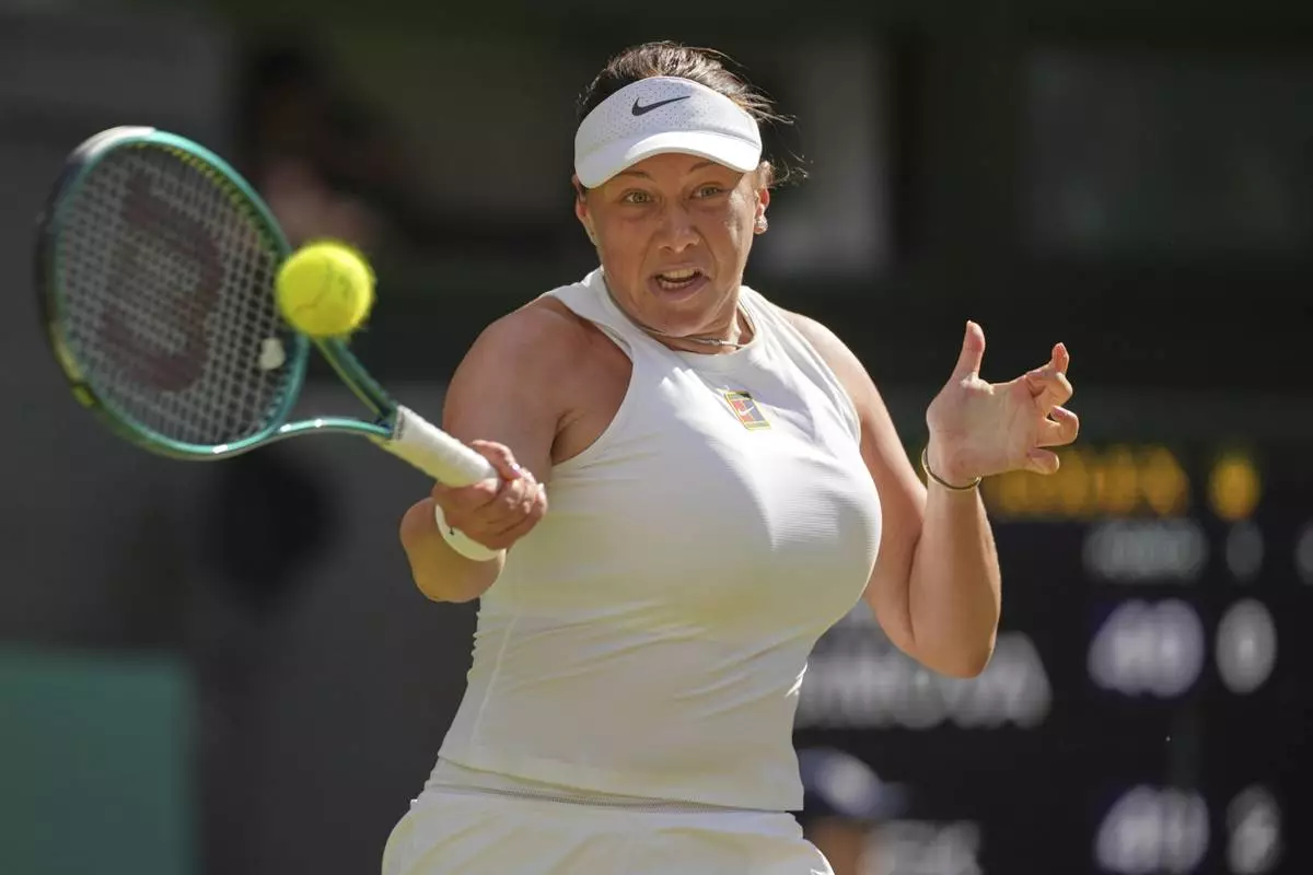 Amanda Anisimova of the U.S. returns to Poland's Iga Swiatek during the women's singles final at the Wimbledon Tennis Championships in London, Saturday, July 12, 2025. (AP Photo/Kin Cheung)