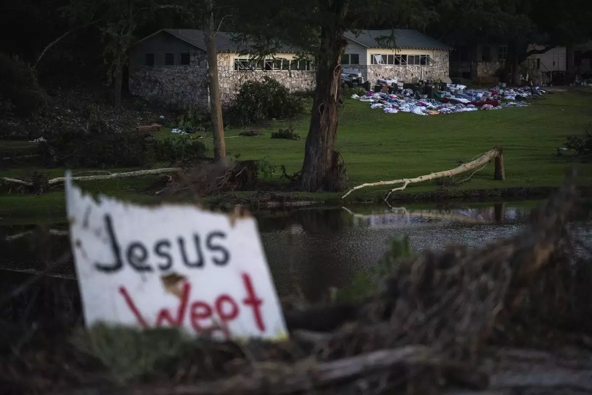 FILE - Camper's belongings sit outside one of Camp Mystic's cabins near the Guadalupe River after a flash flood swept through the area Monday, July 7, 2025, in Hunt, Texas. (AP Photo/Eli Hartman, File)