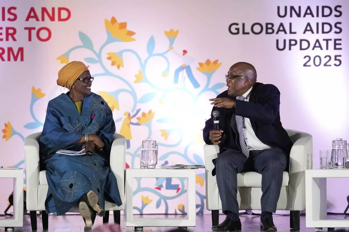 South Africa's Minister of Health Aaron Motsoaledi, right, speaks as Winnie Byanyima, Executive Director of UNAIDS and Under-Secretary-General of the United Nations watches on during the UNAIDS report release at Bertha Gxowa Hospital in Germiston, South Africa, Thursday, July 10, 2025. (AP Photo/Themba Hadebe)