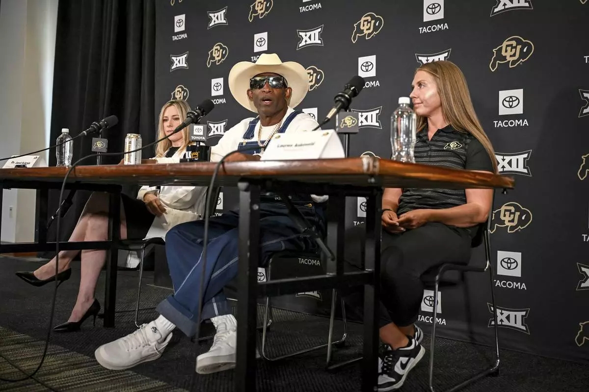 Colorado head coach DeIon Sanders, center, speaks beating bladder cancer during a news conference Monday, July 28, 2025, in Boulder, Colo. (AAron Ontiveroz/The Denver Post via AP)