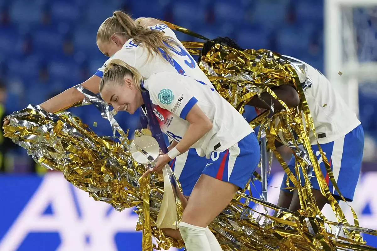 England's Chloe Kelly, front, England's Michelle Agyemang, right, and England's Aggie Beever-Jones celebrate after the Women's Euro 2025 final soccer match between England and Spain at St. Jakob-Park in Basel, Switzerland, Sunday, July 27, 2025. (AP Photo/Martin Meissner)
