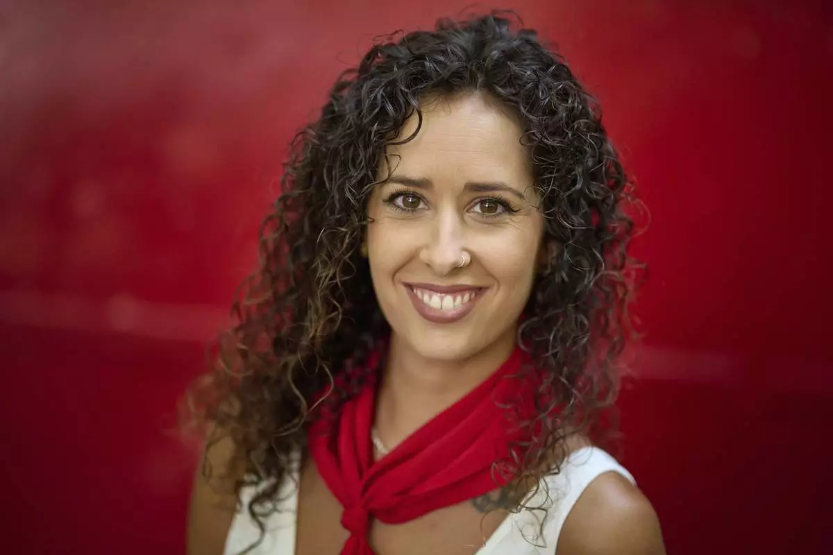 CORRECTS OMARA TO YOMARA - Bull-runner Yomara Martinez poses for a portrait during the San Fermín festival in Pamplona, northern Spain, on Friday, July 11, 2025. (AP Photo/Miguel Oses)