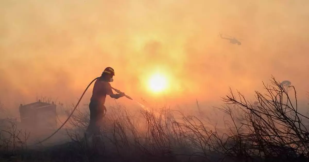 Photos of a wildfire near Athens as homes burn