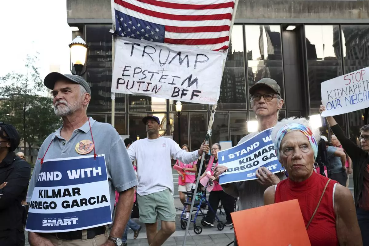 People attend a protest rally at the Immigration and Customs Enforcement field office in Baltimore, Monday, Aug. 25, 2025, to support Kilmar Abrego Garcia. (AP Photo/KT Kanazawich)