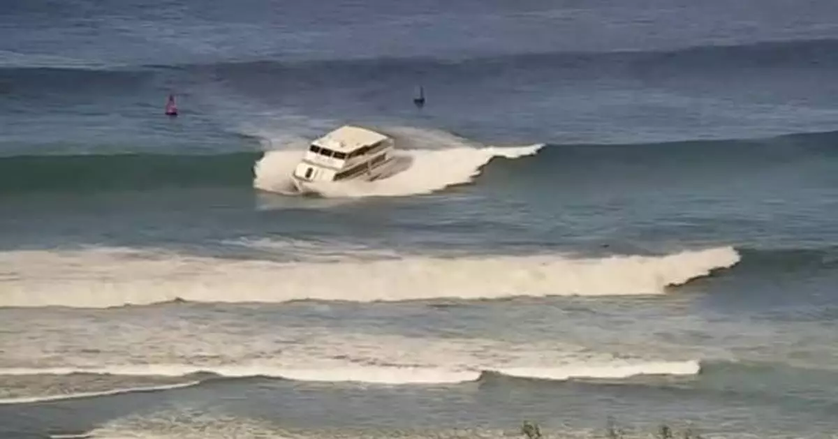 Yacht-sized passenger boat runs aground in high surf off Hawaii beach