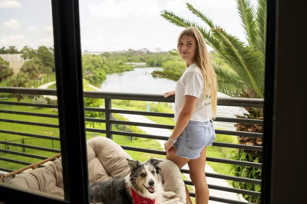 Sophie Nocera, 21, a senior at Eckerd College, poses with her dog Zuco in her college dorm on Wednesday, Aug. 20, 2025 in St. Petersburg, Fla. (AP Photo/Tina Russell)