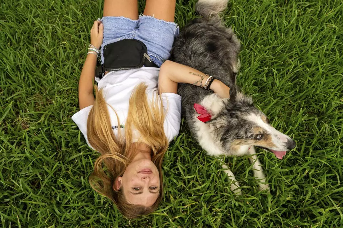Sophie Nocera, 21, a senior at Eckerd College, poses for a photo with her dog Zuco on Wednesday, Aug. 20, 2025 in St. Petersburg, Fla. (AP Photo/Tina Russell)