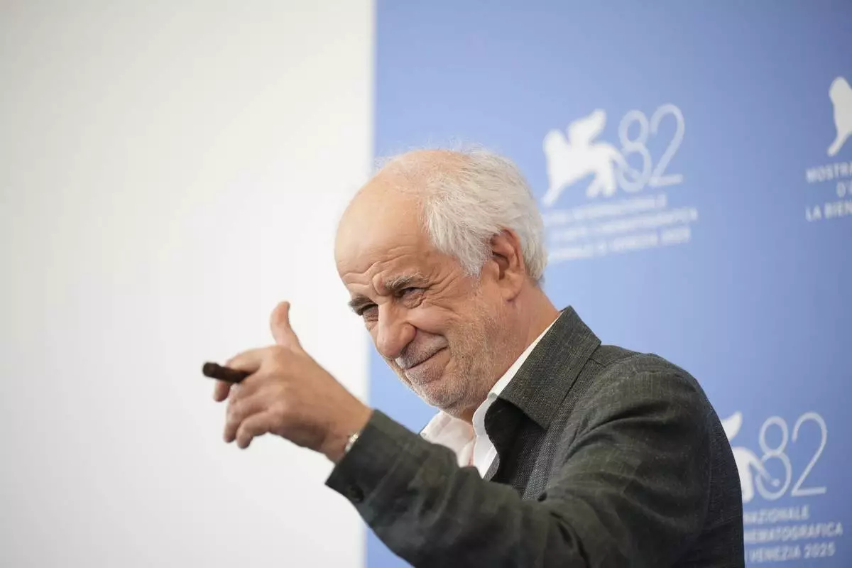 Toni Servillo poses for photographers at the photo call for the film 'La Grazia' during the 82nd edition of the Venice Film Festival in Venice, Italy, on Wednesday, Aug. 27, 2025. (Photo by Alessandra Tarantino/Invision/AP)