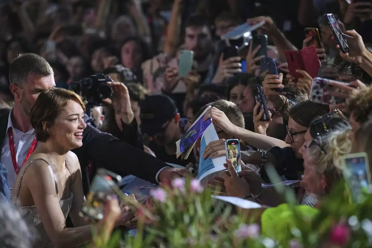 Emma Stone poses for photographers on the red carpet for the film 'Bugonia' during the 82nd edition of the Venice Film Festival in Venice, Italy, on Thursday, Aug. 28, 2025. (Photo by Alessandra Tarantino/Invision/AP)