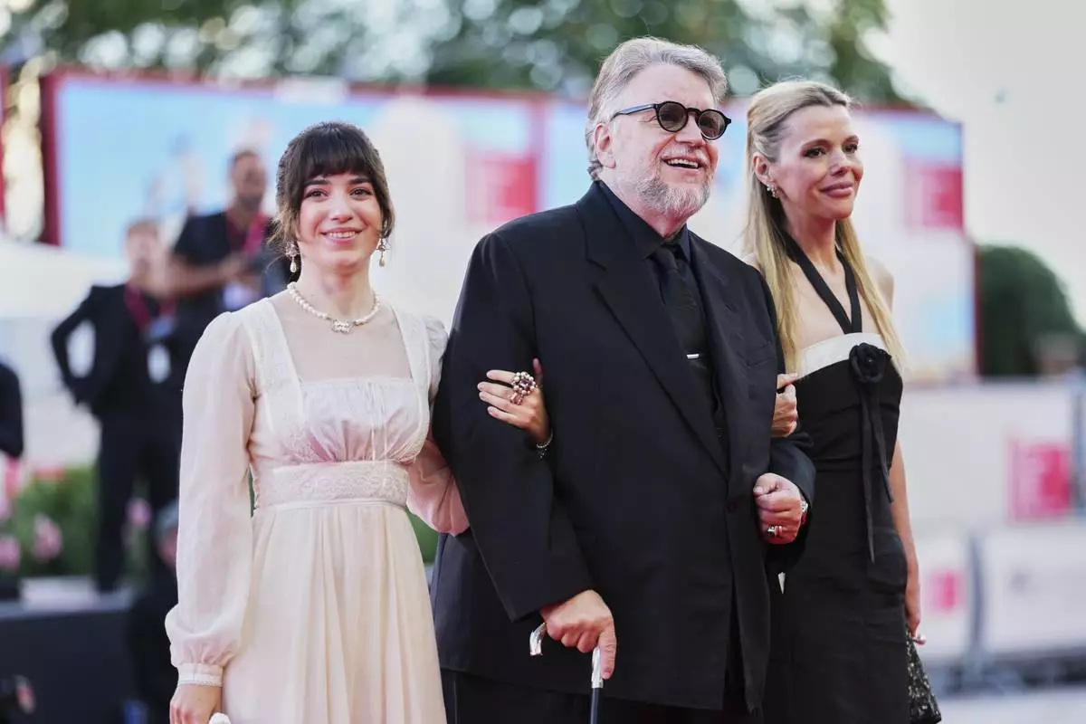 Marisa Del Toro, from left, director Guillermo del Toro and Kim Morgan pose for photographers at the red carpet for the film 'Frankenstein' during the 82nd edition of the Venice Film Festival in Venice, Italy, on Saturday, Aug. 30, 2025. (Photo by Scott A Garfitt/Invision/AP)