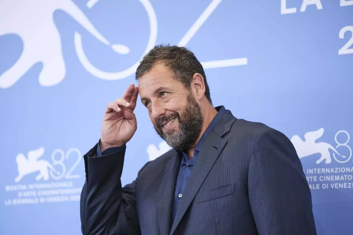 Adam Sandler poses for photographers at the photo call for the film 'Jay Kelly' during the 82nd edition of the Venice Film Festival in Venice, Italy, on Thursday, Aug. 28, 2025. (Photo by Scott A Garfitt/Invision/AP)