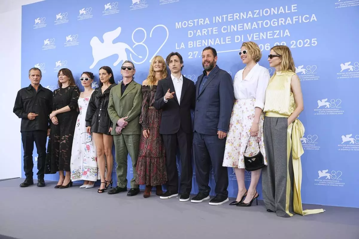 Producer David Heyman, from left, Emily Mortimer, Eve Hewson, Riley Keough, Billy Crudup, Laura Dern, director Noah Baumbach, Adam Sandler, Greta Gerwig and Alba Rohrwacher pose for photographers at the photo call for the film 'Jay Kelly' during the 82nd edition of the Venice Film Festival in Venice, Italy, on Thursday, Aug. 28, 2025. (Photo by Scott A Garfitt/Invision/AP)