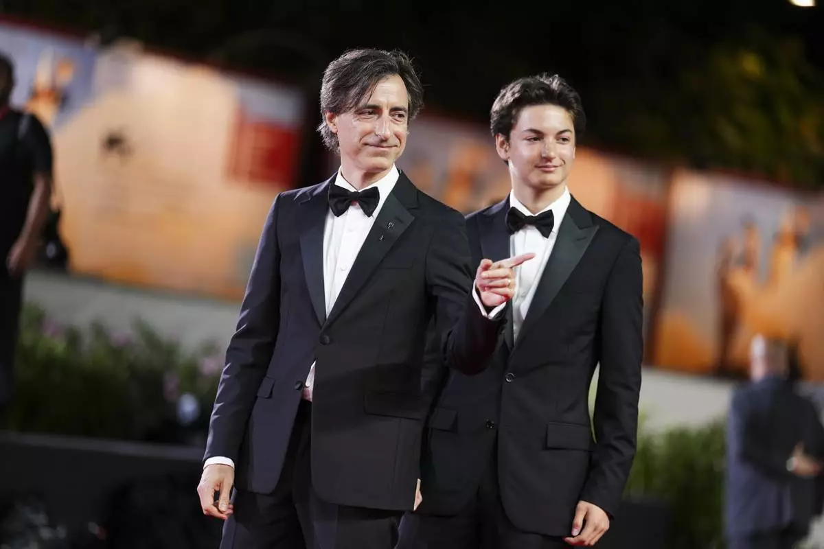 Director Noah Baumbach, left, and Rohmer Baumbach pose for photographers at the red carpet for the film 'Jay Kelly' during the 82nd edition of the Venice Film Festival in Venice, Italy, on Thursday, Aug. 28, 2025. (Photo by Scott A Garfitt/Invision/AP)