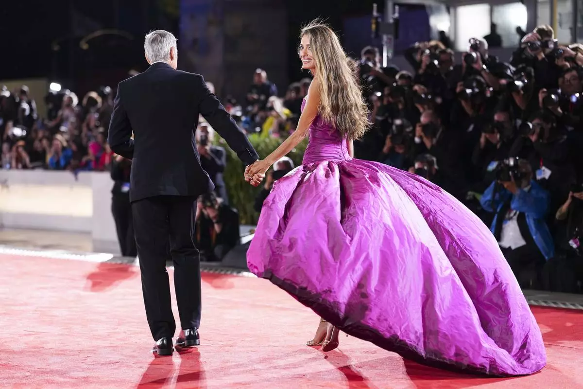 George Clooney, left, and Amal Clooney pose for photographers at the red carpet for the film 'Jay Kelly' during the 82nd edition of the Venice Film Festival in Venice, Italy, on Thursday, Aug. 28, 2025. (Photo by Scott A Garfitt/Invision/AP)