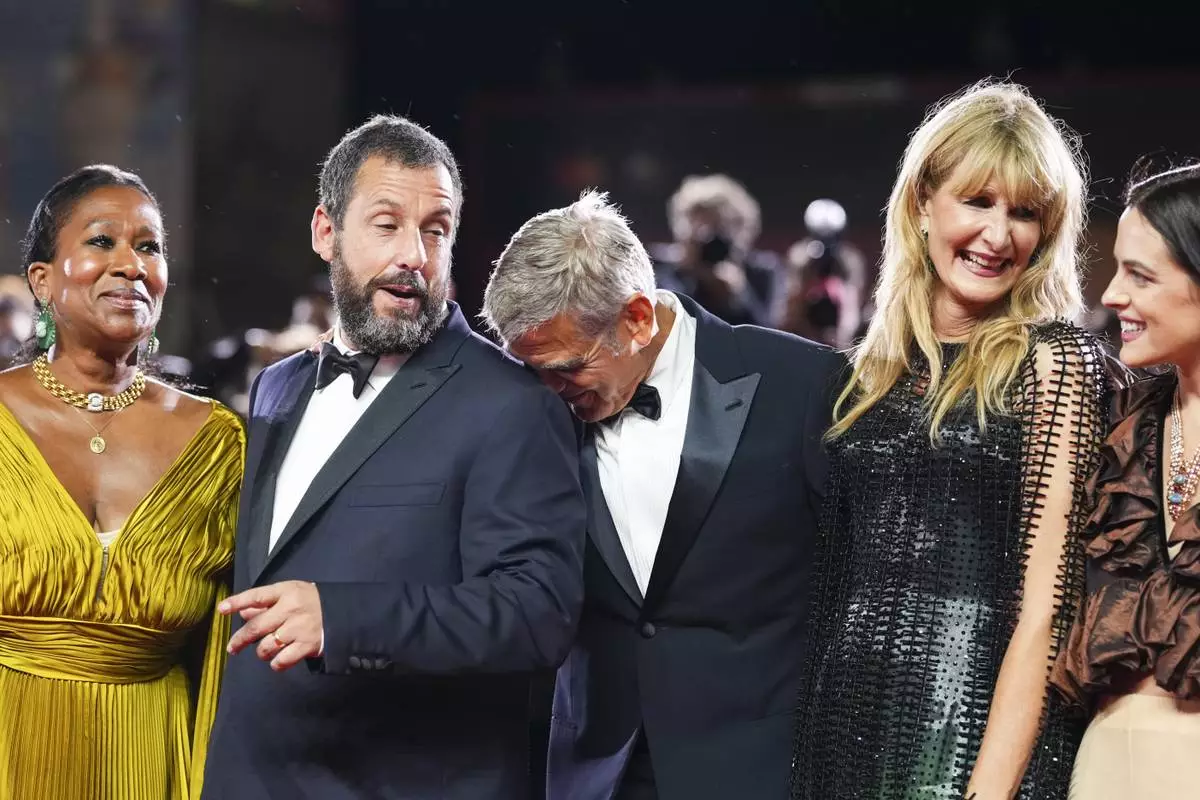 Nicole Avant, from left, Adam Sandler, George Clooney, Laura Dern, and Riley Keough pose for photographers at the red carpet for the film 'Jay Kelly' during the 82nd edition of the Venice Film Festival in Venice, Italy, on Thursday, Aug. 28, 2025. (Photo by Scott A Garfitt/Invision/AP)