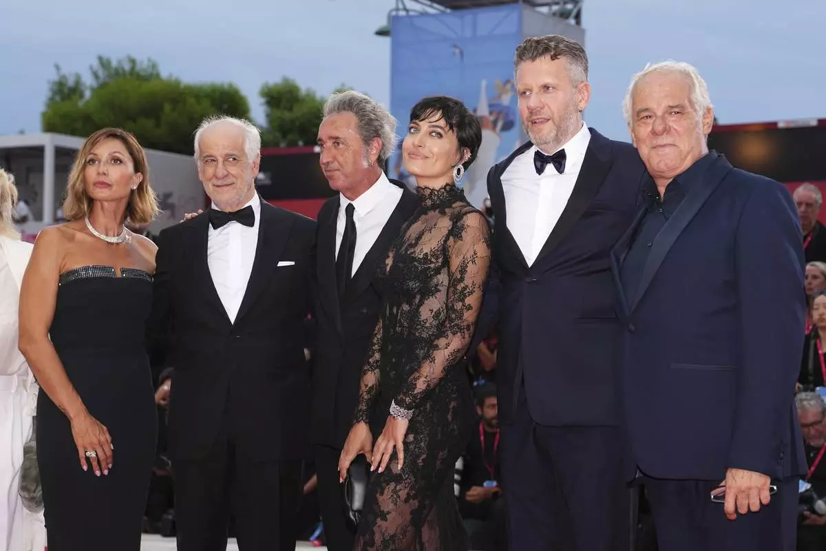 Anna Ferzetti, from left, Toni Servillo, director Paolo Sorrentino, Linda Messerklinger, Orlando Cinque, and Giuseppe Gaiani pose for photographers on the red carpet for the opening ceremony and the premiere of the film 'La Grazia' during the 82nd edition of the Venice Film Festival in Venice, Italy, on Wednesday, Aug. 27, 2025. (Photo by Scott A Garfitt/Invision/AP)