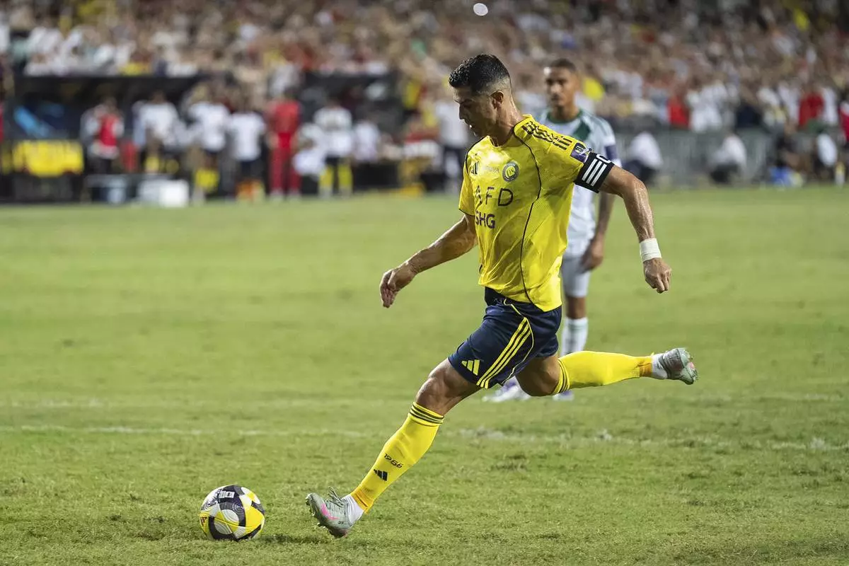 Al Nassr's Cristiano Ronaldo scores a goal with a penalty kick during the Saudi Super Cup final soccer match between Al Ahli and Al Nassr at the Hong Kong Stadium in Hong Kong, Saturday, Aug. 23, 2025. (AP Photo/Chan Long Hei)