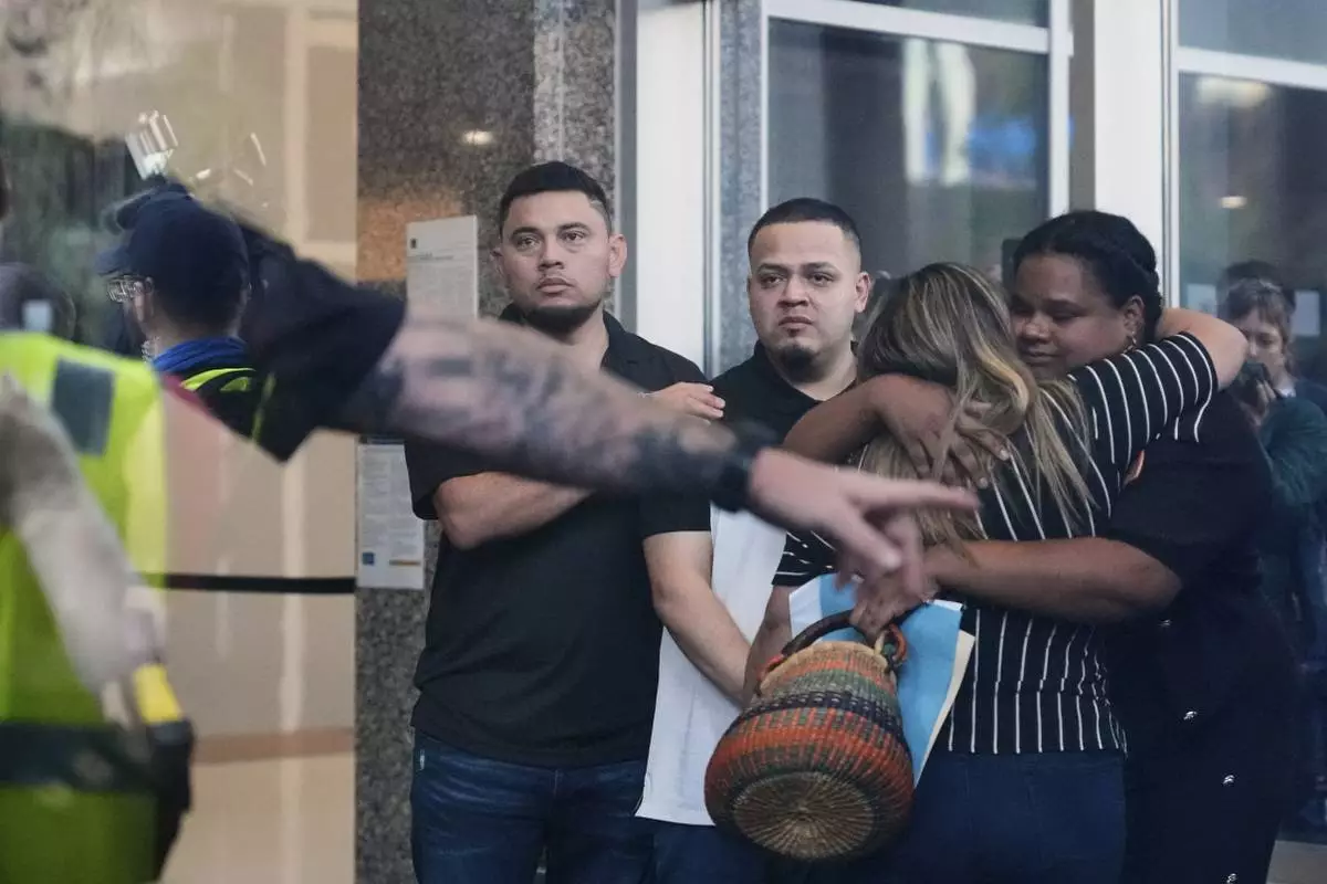 Kilmar Abrego Garcia, center, and his brother Cesar Abrego Garcia, left, arrive at the Immigration and Customs Enforcement field office in Baltimore, Monday, Aug. 25, 2025. (AP Photo/Stephanie Scarbrough)