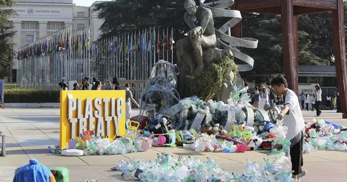 Artist drowns sculpture in plastic waste in front of the UN during plastic pollution treaty talks