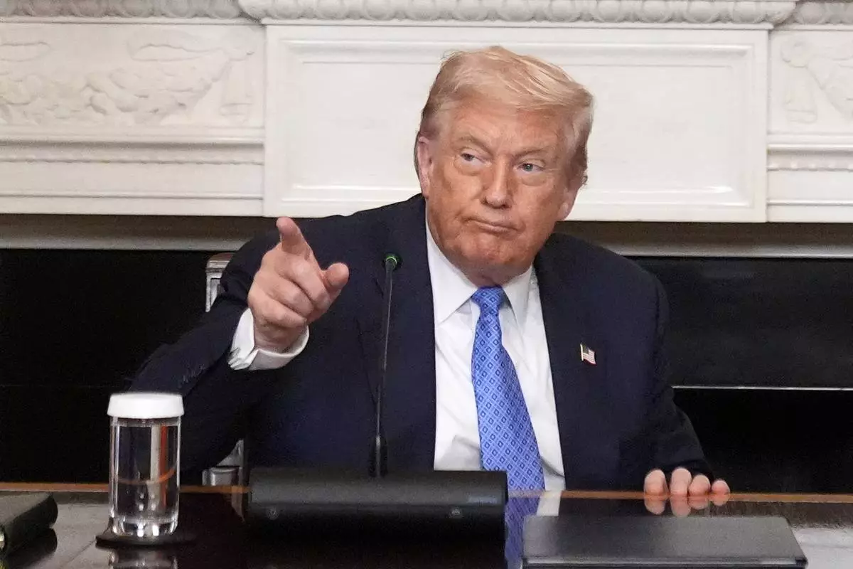President Donald Trump gestures during a trilateral signing ceremony with Armenian Prime Minister Nikol Pashinyan and Azerbaijan President Ilham Aliyev in the State Dining Room of the White House, Friday, Aug. 8, 2025, in Washington. (AP Photo/Mark Schiefelbein)